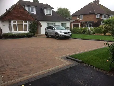 Brindle block paved driveway in front of a detached house