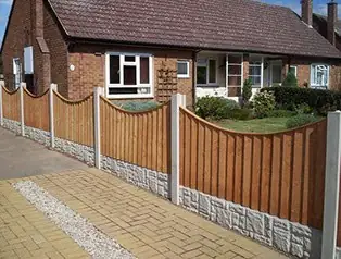 Closeboard timber fence panels with concrete gravel boards along a front garden