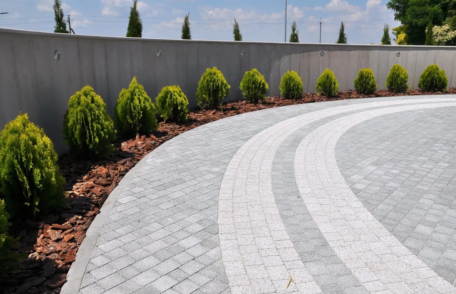 Curved grey block paved driveway with contrasting banding